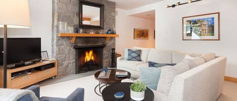Cozy living room with stone faced fireplace