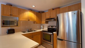 Well-equipped kitchen with large counters and stainless steel appliances
