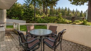 Private patio looking on to the ski hill with seating for four and BBQ