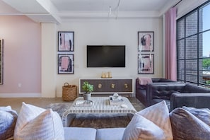 Living Area Includes Large TV and Chic Furnishings.