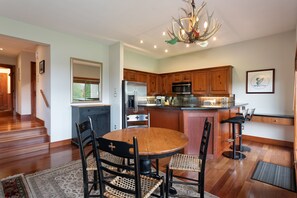 Dining area with seating for four, or six with extension, and two at the breakfast bar
