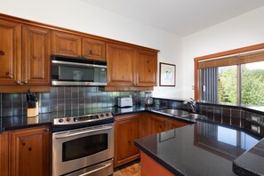 Fully equipped kitchen with plenty of counter space and a breakfast bar