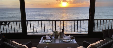 Romantic dinner over sunset alley on the Pacific Ocean with soft music and waves