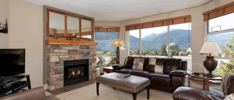 Spacious living room with gas fireplace and TV