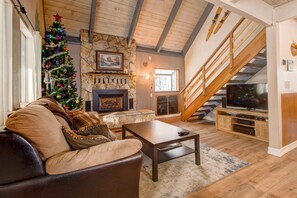 Living room with gas fireplace, SmartTV, video games, & sofa sleeper