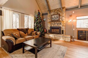 Living room with gas fireplace, SmartTV, video games, & sofa sleeper