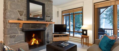 Cosy living space with open fire and views onto the ski run