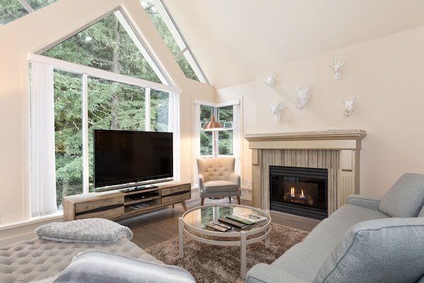 Inviting living area with gas fireplace, large TV