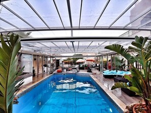 Retractable cover over heated pool and deck area for all year round fun and use