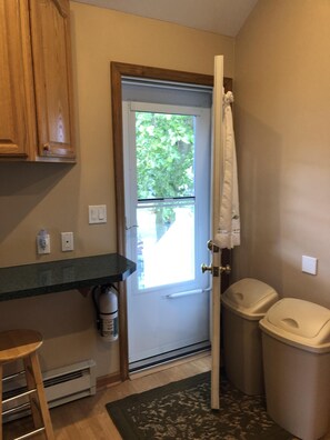 Kitchen back door leading to grill area and patio. 