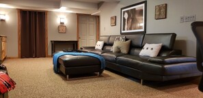 Extra Large Living Room Couch. Door is to laundry room & curtain to gym