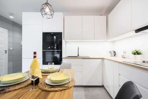 Kitchenette with oven and refrigerator. 