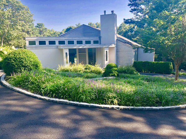 Front of house, multiple parking areas, 