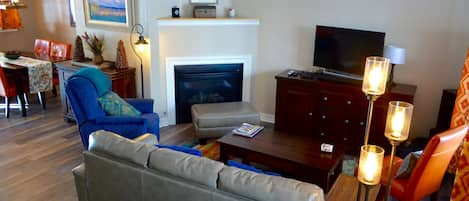 Living Room and Dining Area - The main level is open and spacious, with the living room area flowing into the dining room and fully equipped kitchen.