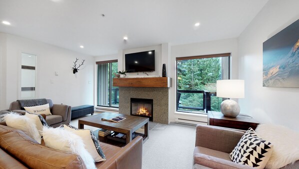 Living area with gas fireplace, TV, patio access