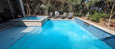 Salt-water pool and spa w tanning shelf, fountains, deck jets and water falls.