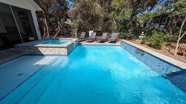 Salt-water pool and spa w tanning shelf, fountains, deck jets and water falls.