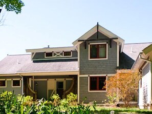 Front of house with a circle drive and covered porch
