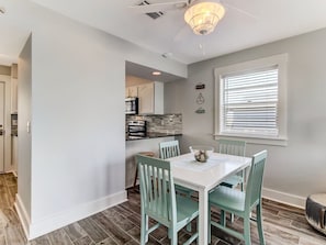 View of dining area with breakfast bar in the background