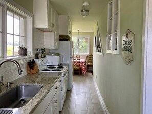 Updated farmhouse galley kitchen fully equipped for all your cooking needs.