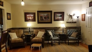 Seating in Living room, leather chairs with foot stool and toss pillows,