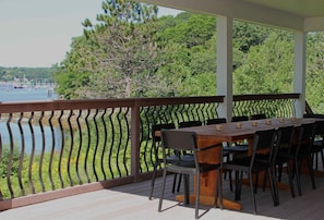 This outdoor deck seats 12 for a meal or cocktails over the ocean. 