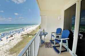 Balcony off of living rom with seating and table for 2