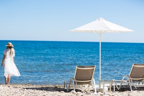 A private beach, (with sun beds and umbrellas exclusively at your disposal)!
