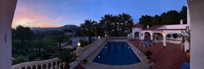 Panoramic shot of the pool and main terrace at dusk