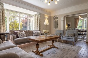 Ground floor: Sitting room with comfortable sofas and stylish armchairs