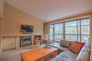 Living room with a relaxing flat screen TV and cozy fireplace