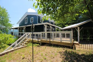 The deck wraps around to the back and the stunning views. Carport/upper parking