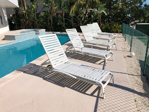 8 lounge chairs by pool