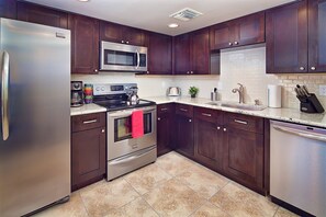 Upgraded kitchen with solid wood cabinets and granite counters.