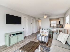 Looking from sliding patio doors toward living area, dining area and kitchen