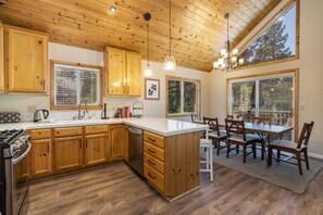 Open kitchen with new lighting and appliances