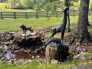 Bronze giraffes and lion greet you on the drive into the farm