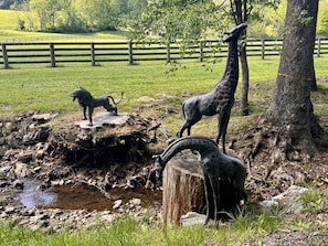 Bronze giraffes and lion greet you on the drive into the farm