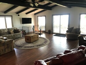 Great room w/ Door To Carpeted Shaded Deck