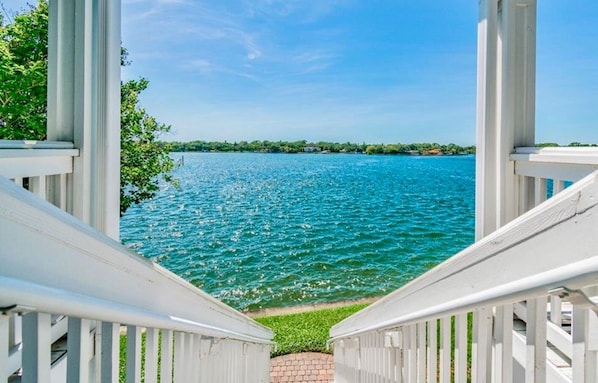 Private covered balcony stairs lead directly to the water