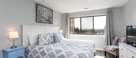 Wake up in this King bed to gorgeous views of the bay in this beautifully lit master bedroom.