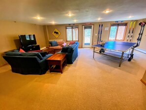 Designed for relaxation and entertainment, the home features a lower-level game and living room—perfect for family fun on rainy days.