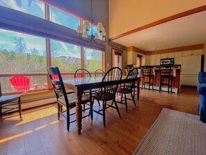 An open concept living/dining area offers a dining table for six,