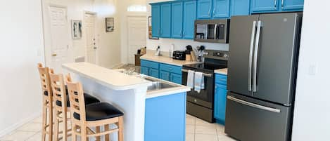 Bright kitchen stocked with appliances