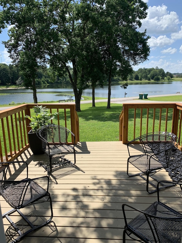 Enjoy sunsets on Master bedroom porch; fire pit and chairs 