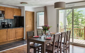 Prepare meals in the kitchenette and enjoy them at the dining table.