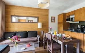 Prepare meals in the kitchenette and enjoy them at the dining table.