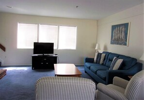 Living room features queen-size pull-out sofa bed