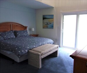 Master bedroom features king-sized bed and lighted make-up vanity