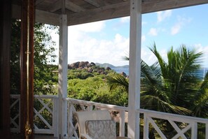 View from inside living room across the deck and out to the rocks at the Baths.